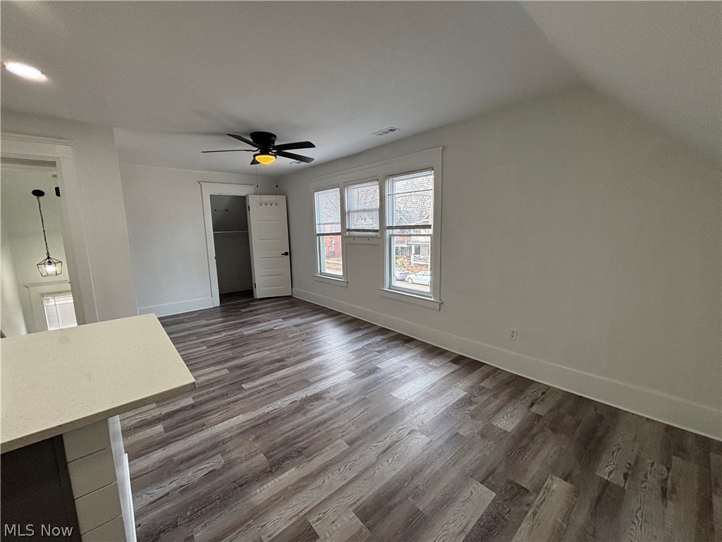 4115 Whitman Avenue, Unit UP Cleveland, OH 44113 - Photo 4 of 12 Unfurnished bedroom with dark wood-style floors, a closet, ceiling fan, and lofted ceiling