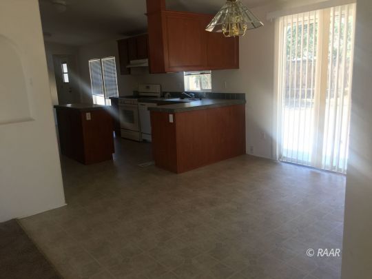 1409 Pinto Street Ridgecrest, CA 93555 - Photo 3 of 12 a kitchen with stainless steel appliances granite countertop a stove a sink a refrigerator and a microwave oven
