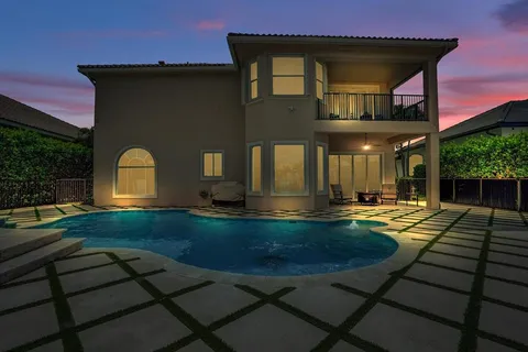 a kitchen with a refrigerator and a potted plant