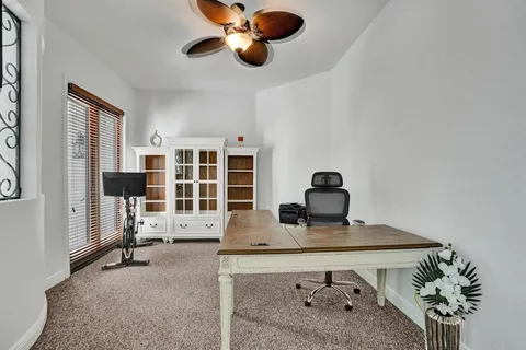 a dining room with furniture and a chandelier
