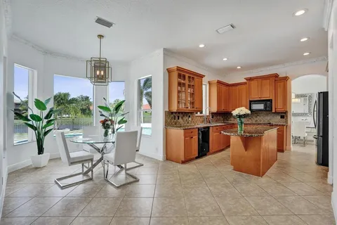 a spacious bathroom with a tub sink and mirror