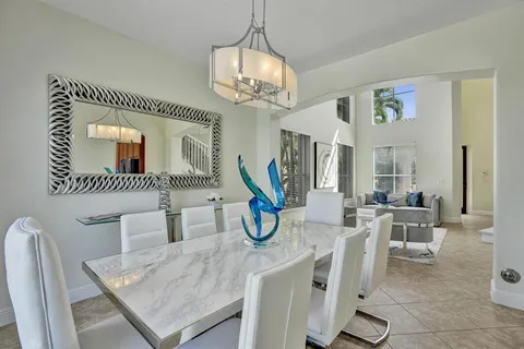 an aerial view of a residential houses with outdoor space and lake view