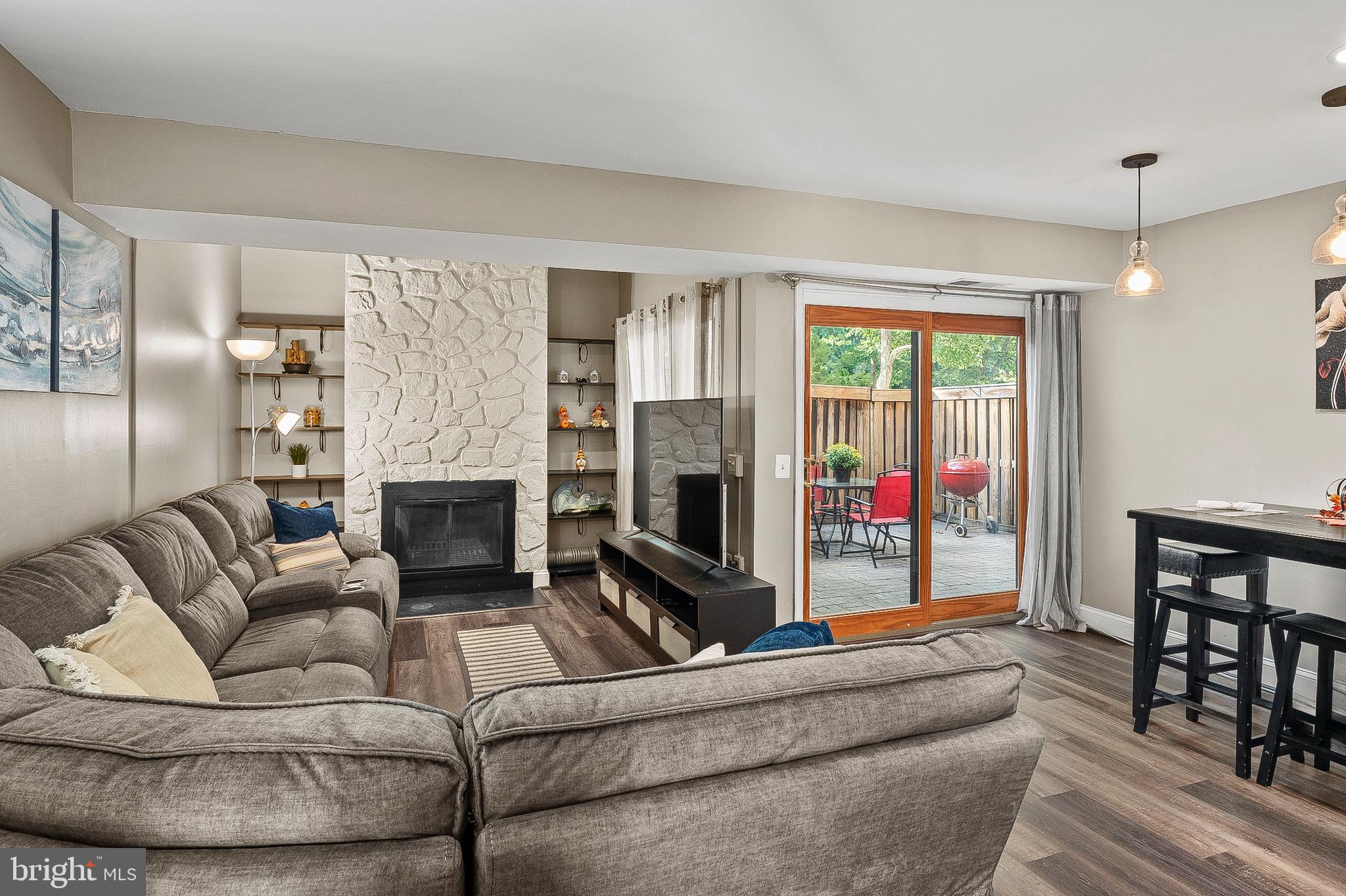 11238 Crystal Run, Unit A Columbia, MD 21044 - Photo 6 of 33 Living w/ wood burning FPL & decorative shelving