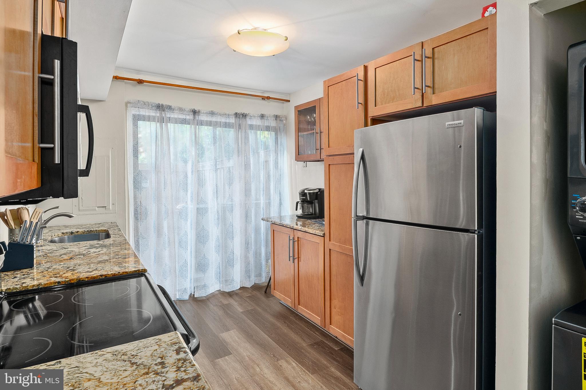 11238 Crystal Run, Unit A Columbia, MD 21044 - Photo 9 of 33 Kitchen w/ granite counters & exit to patio
