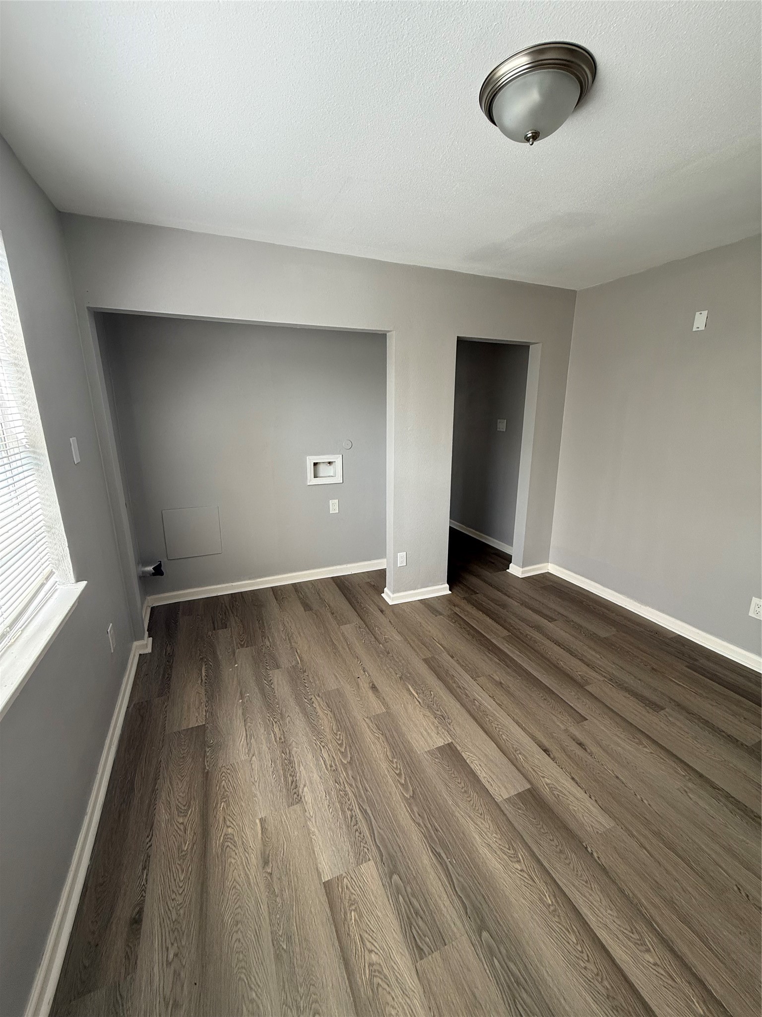 4315 Chapman Street Houston, TX 77009 - Photo 8 of 12 an empty room with wooden floor and windows