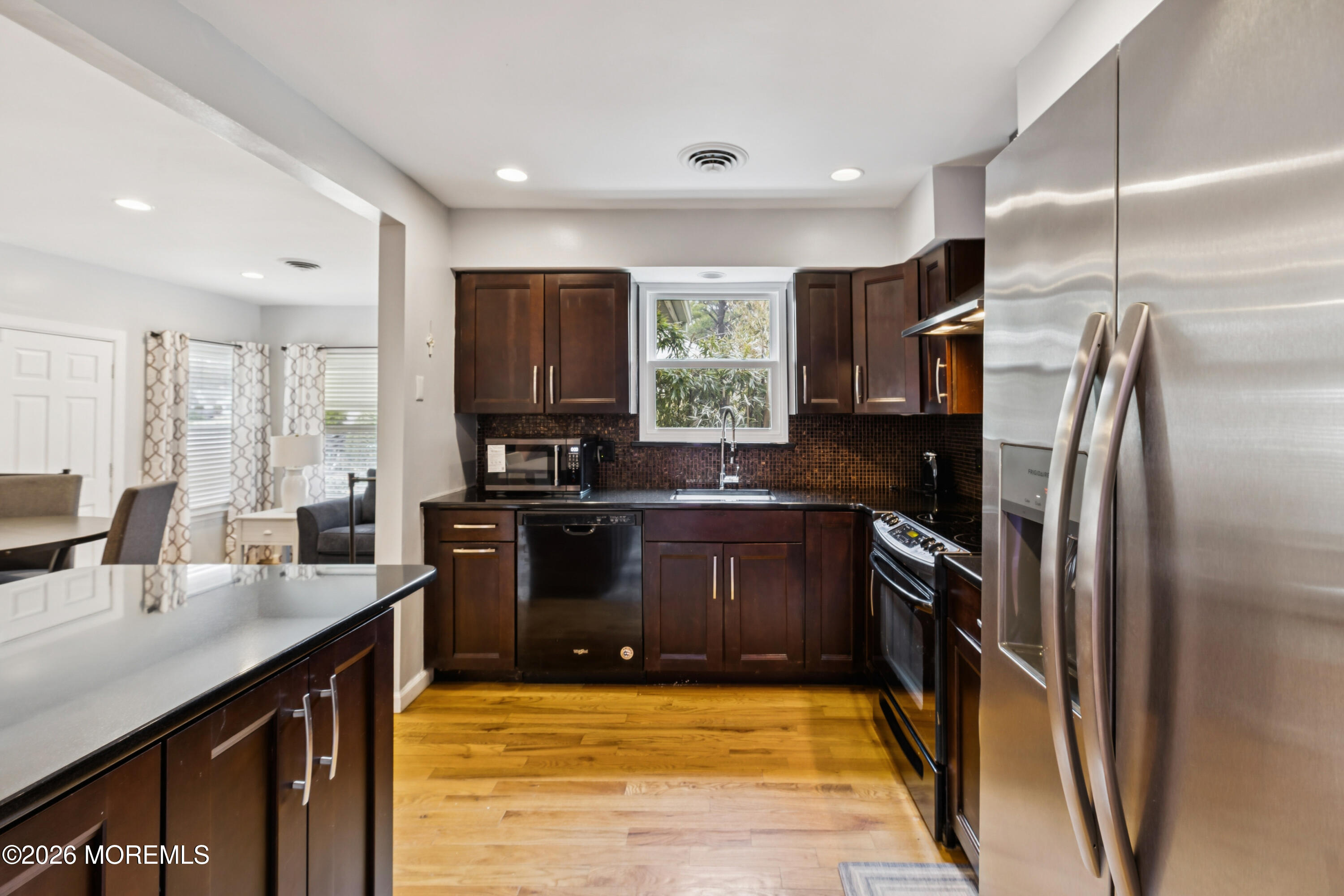 65 A Sunset Road, Unit 60 Whiting, NJ 08759 - Photo 12 of 24 a kitchen with granite countertop a refrigerator stove and sink