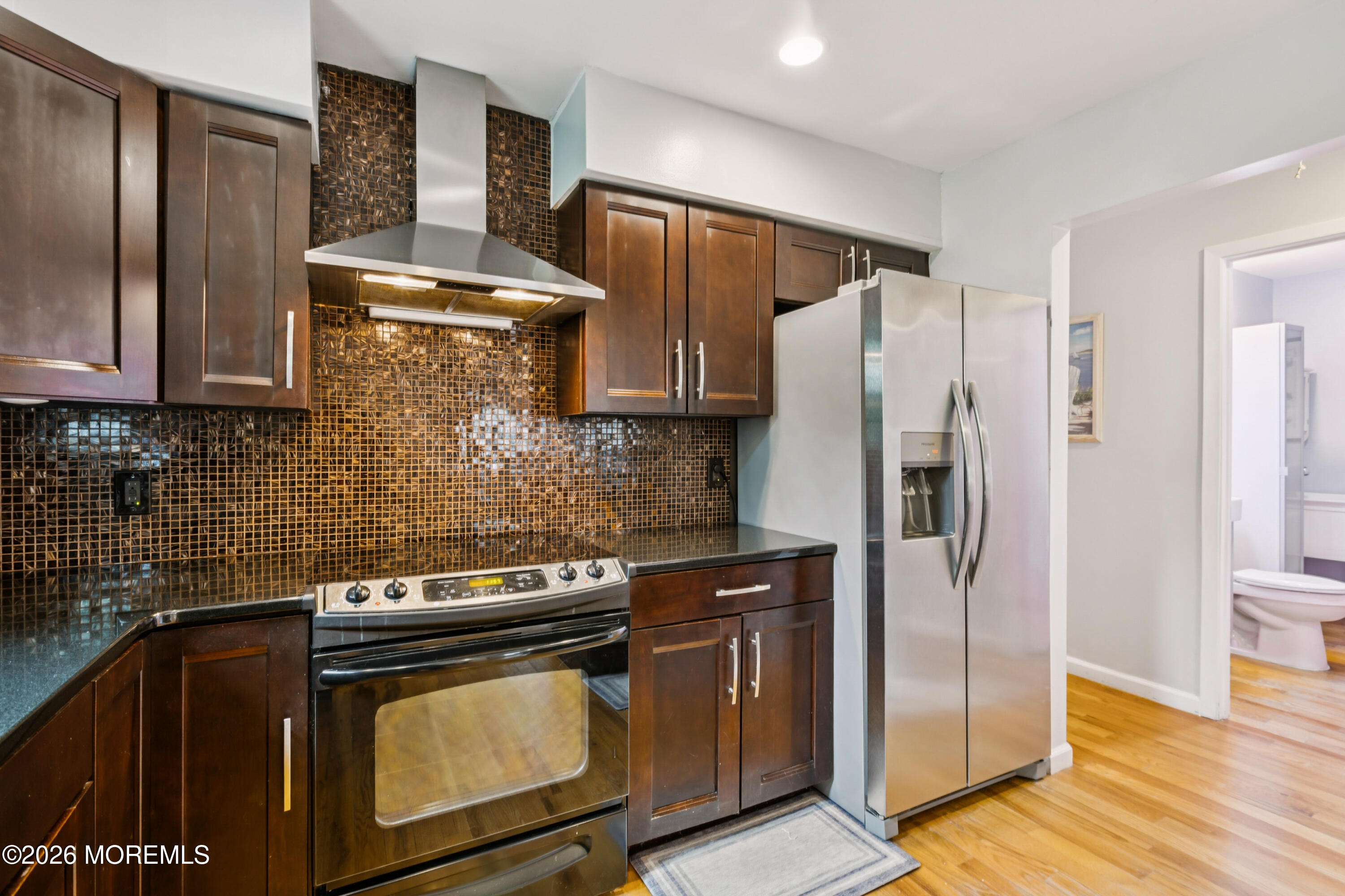 65 A Sunset Road, Unit 60 Whiting, NJ 08759 - Photo 13 of 24 a kitchen with stainless steel appliances granite countertop a refrigerator and a stove
