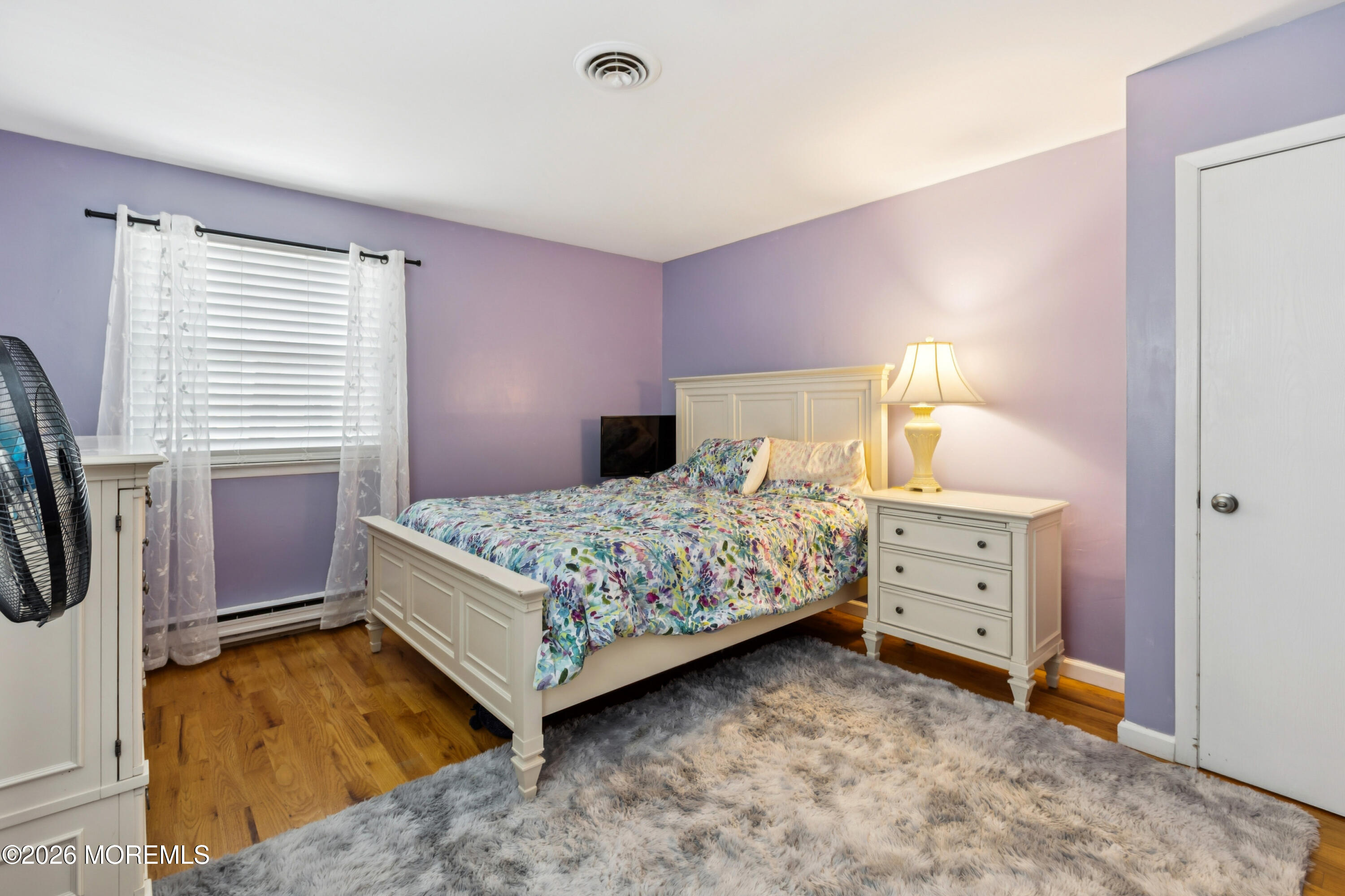 65 A Sunset Road, Unit 60 Whiting, NJ 08759 - Photo 17 of 24 a bedroom with a bed and a flat tv screen on dresser