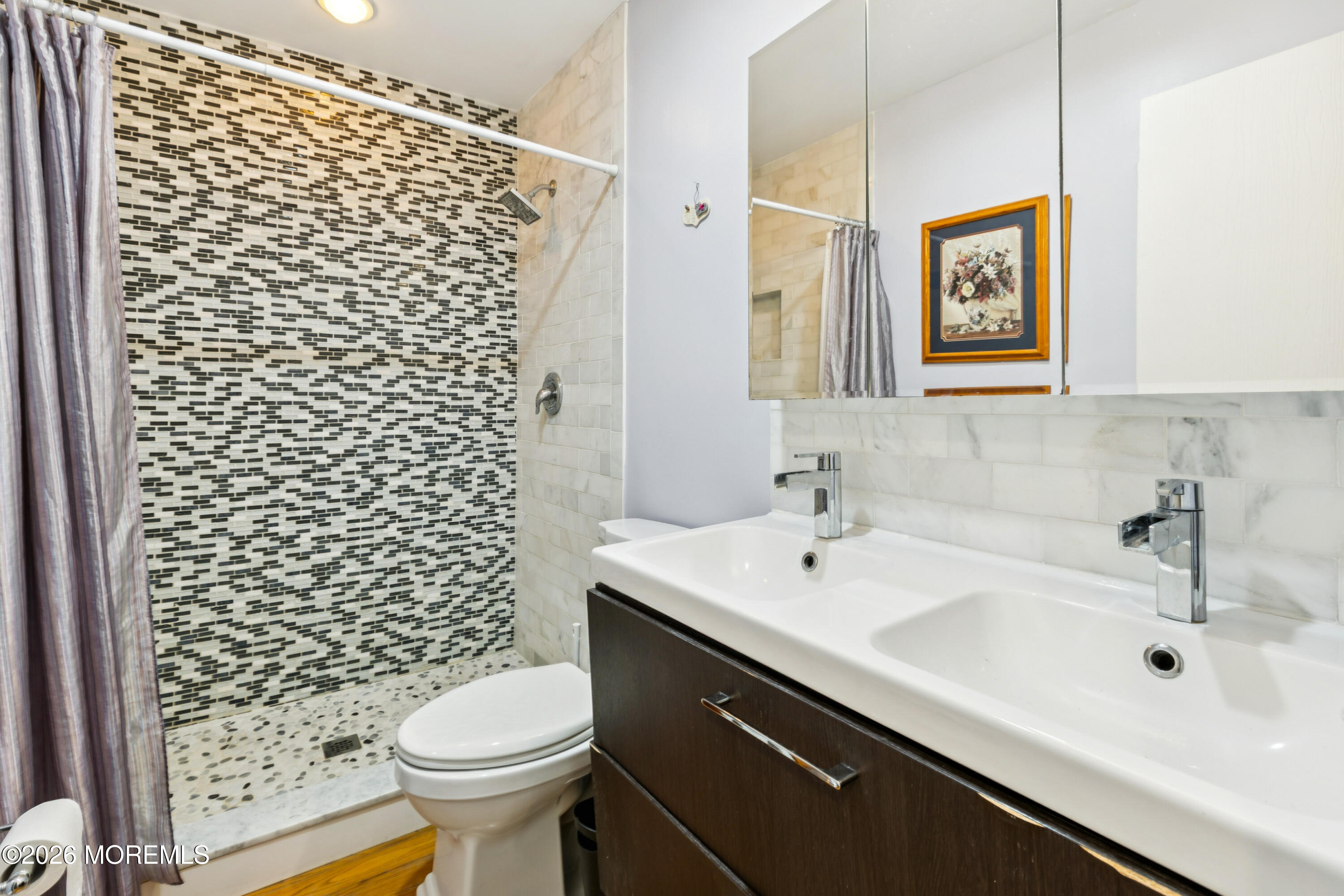 65 A Sunset Road, Unit 60 Whiting, NJ 08759 - Photo 18 of 24 a bathroom with a sink a toilet and shower curtain