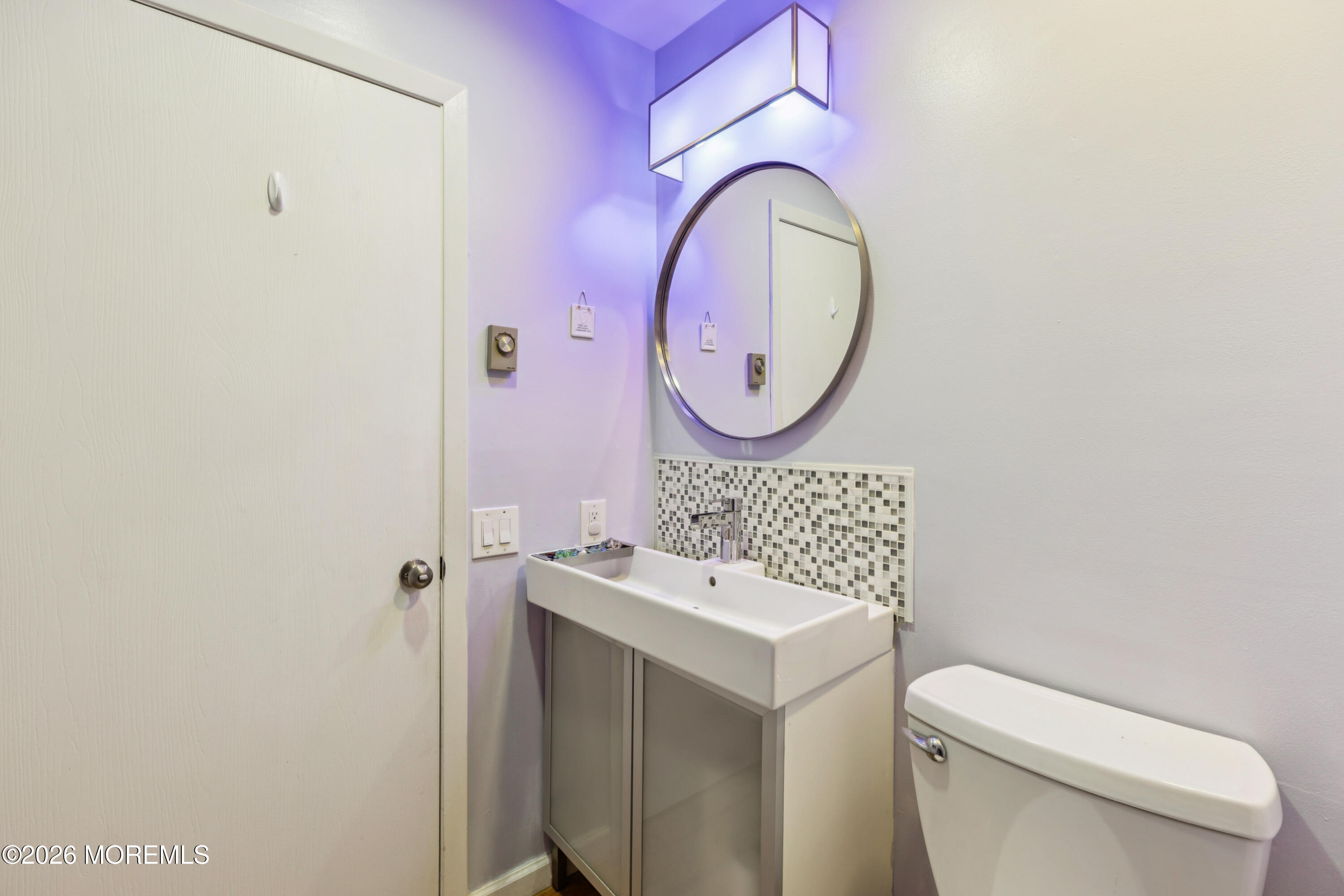 65 A Sunset Road, Unit 60 Whiting, NJ 08759 - Photo 22 of 24 a bathroom with a toilet sink and mirror