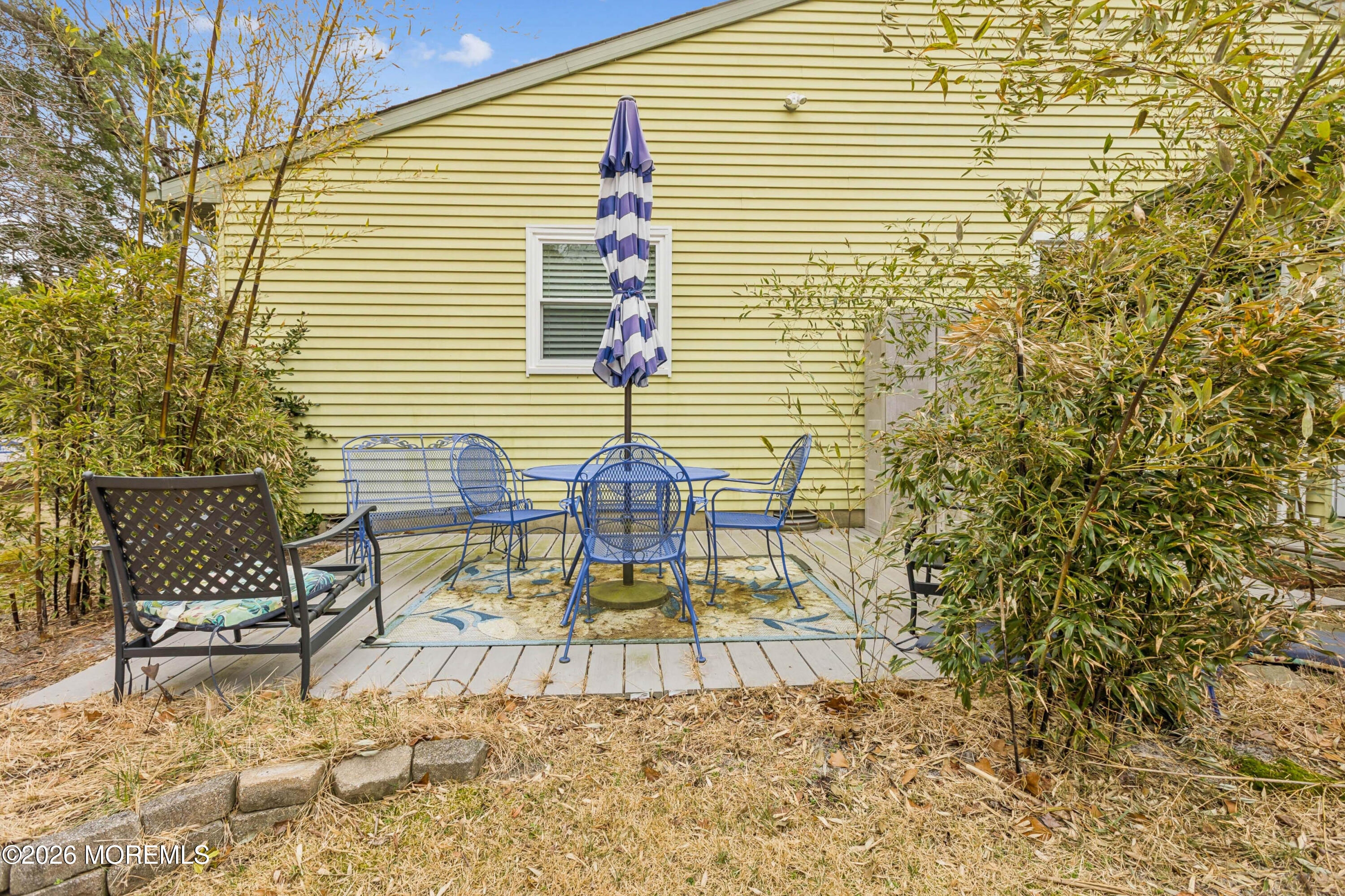 65 A Sunset Road, Unit 60 Whiting, NJ 08759 - Photo 23 of 24 a view of a porch with chairs and wooden fence