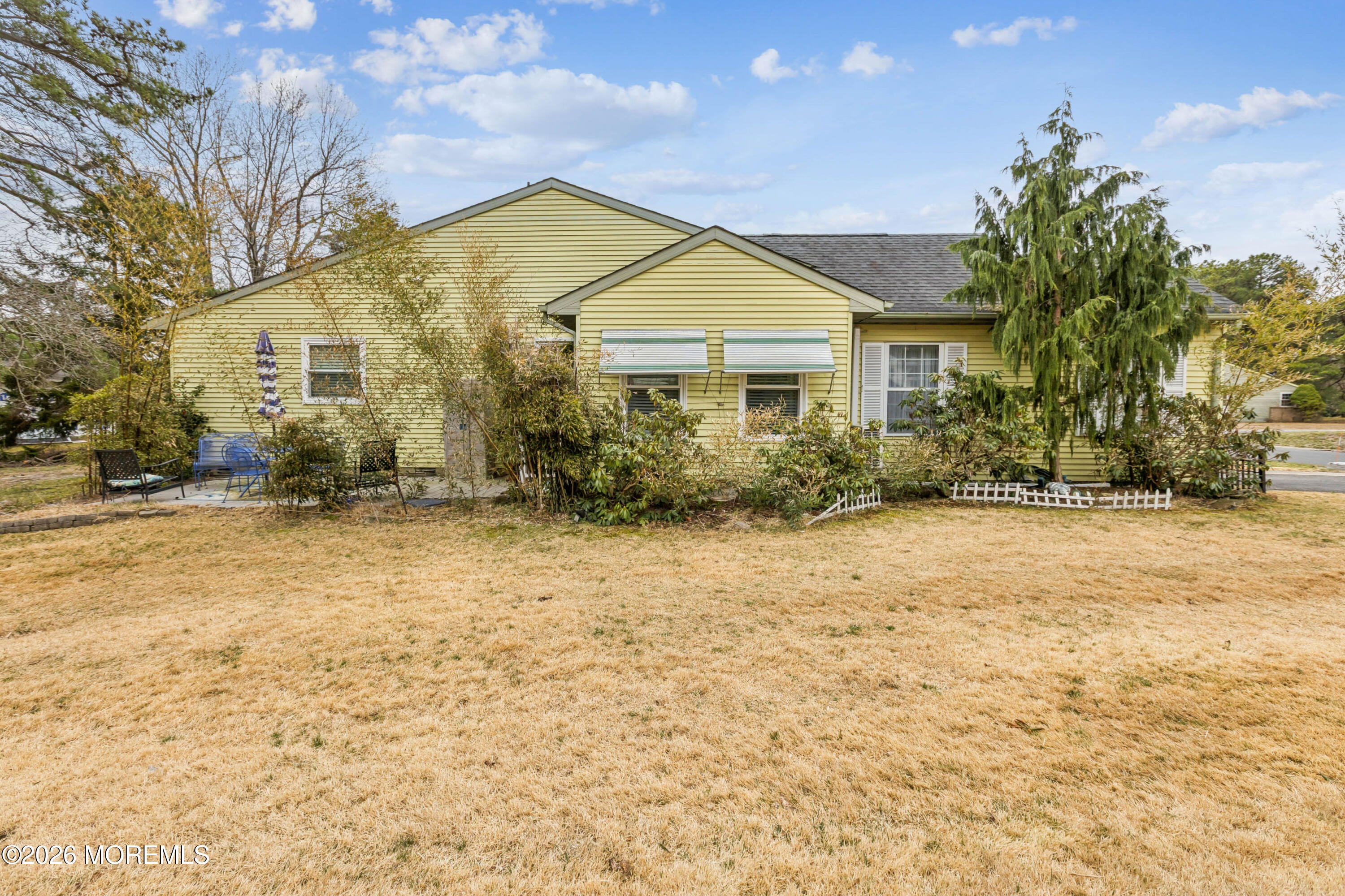 65 A Sunset Road, Unit 60 Whiting, NJ 08759 - Photo 24 of 24 a view of a white house next to a yard with large trees