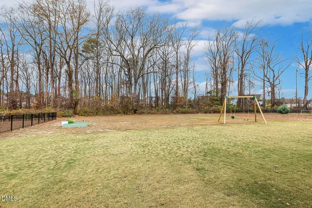 a view of backyard with a deck and wooden floor