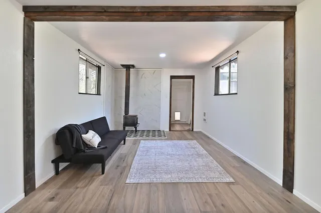 a living room with furniture and a wooden floor