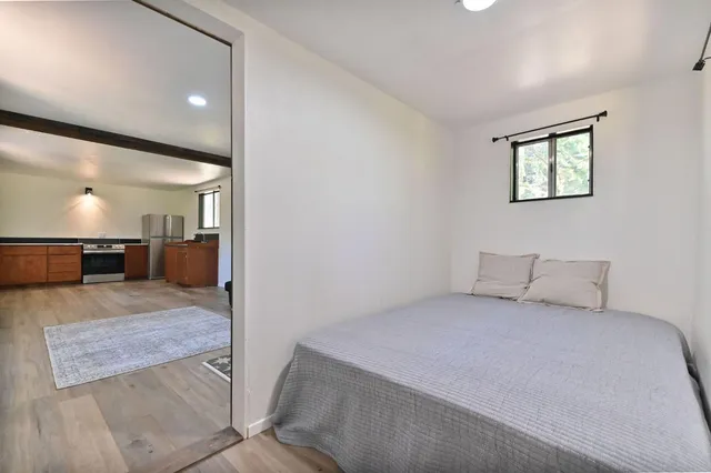 a bedroom with a large bed and a large mirror