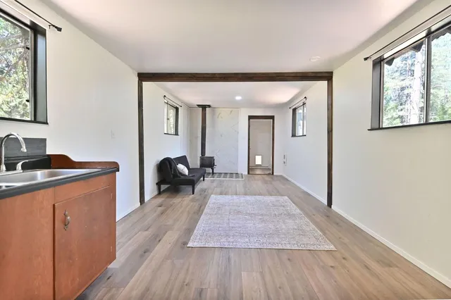 a spacious bedroom with a large bed and a chandelier