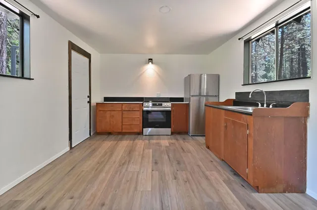 a kitchen with stainless steel appliances granite countertop a stove and a refrigerator