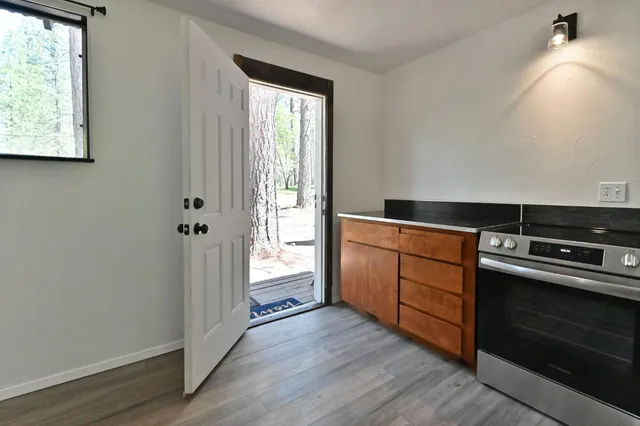 a kitchen with wooden floors and a stove