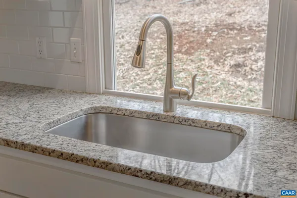 a living room with a fireplace and a hard wood floor