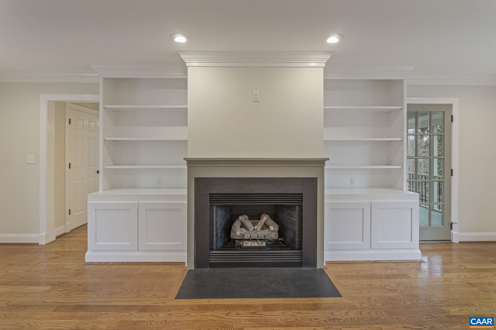 4053 Free Union Road Charlottesville, VA 22901 - Photo 28 of 67 a living room with a fireplace and a hard wood floor