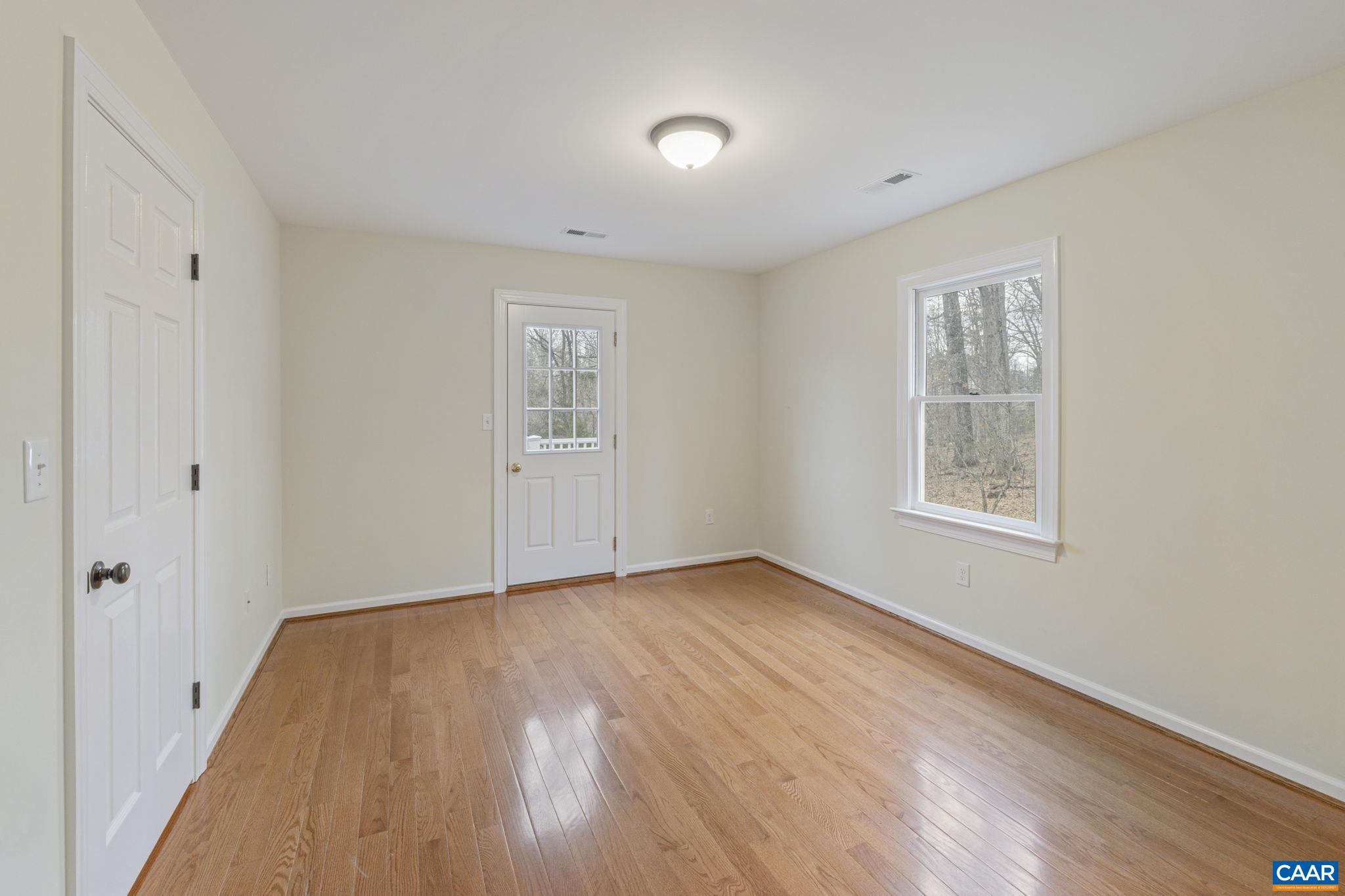 4053 Free Union Road Charlottesville, VA 22901 - Photo 37 of 67 a view of an empty room with wooden floor and a window