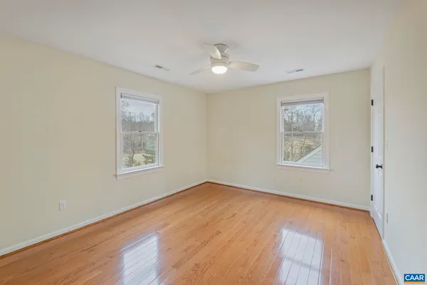 a view of a white house with wooden walls and stairs