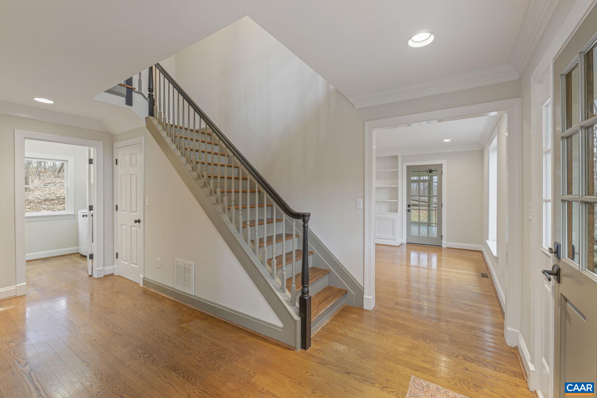 4053 Free Union Road Charlottesville, VA 22901 - Photo 10 of 67 a view of an entryway with wooden floor leading to a furnished livingroom and windows