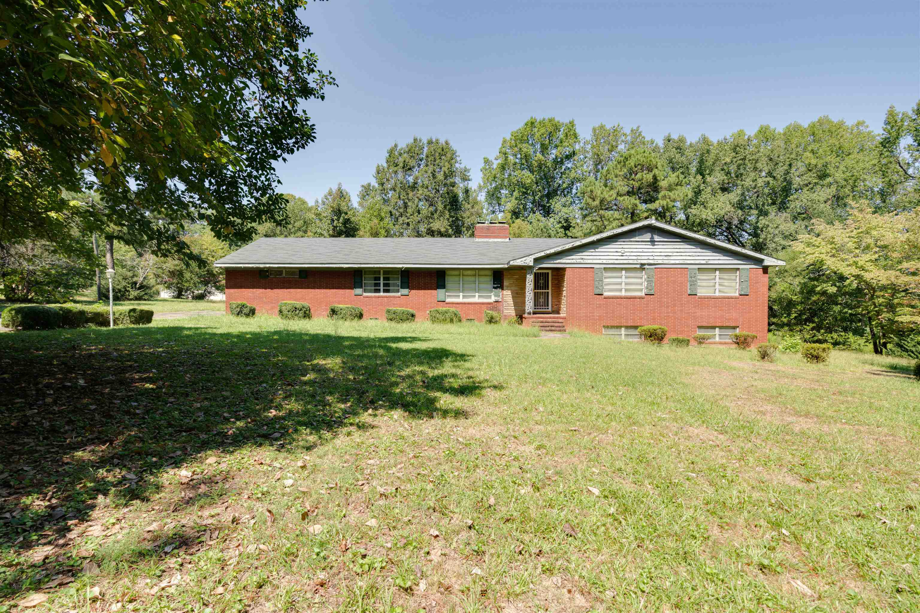 a view of house with backyard and garden