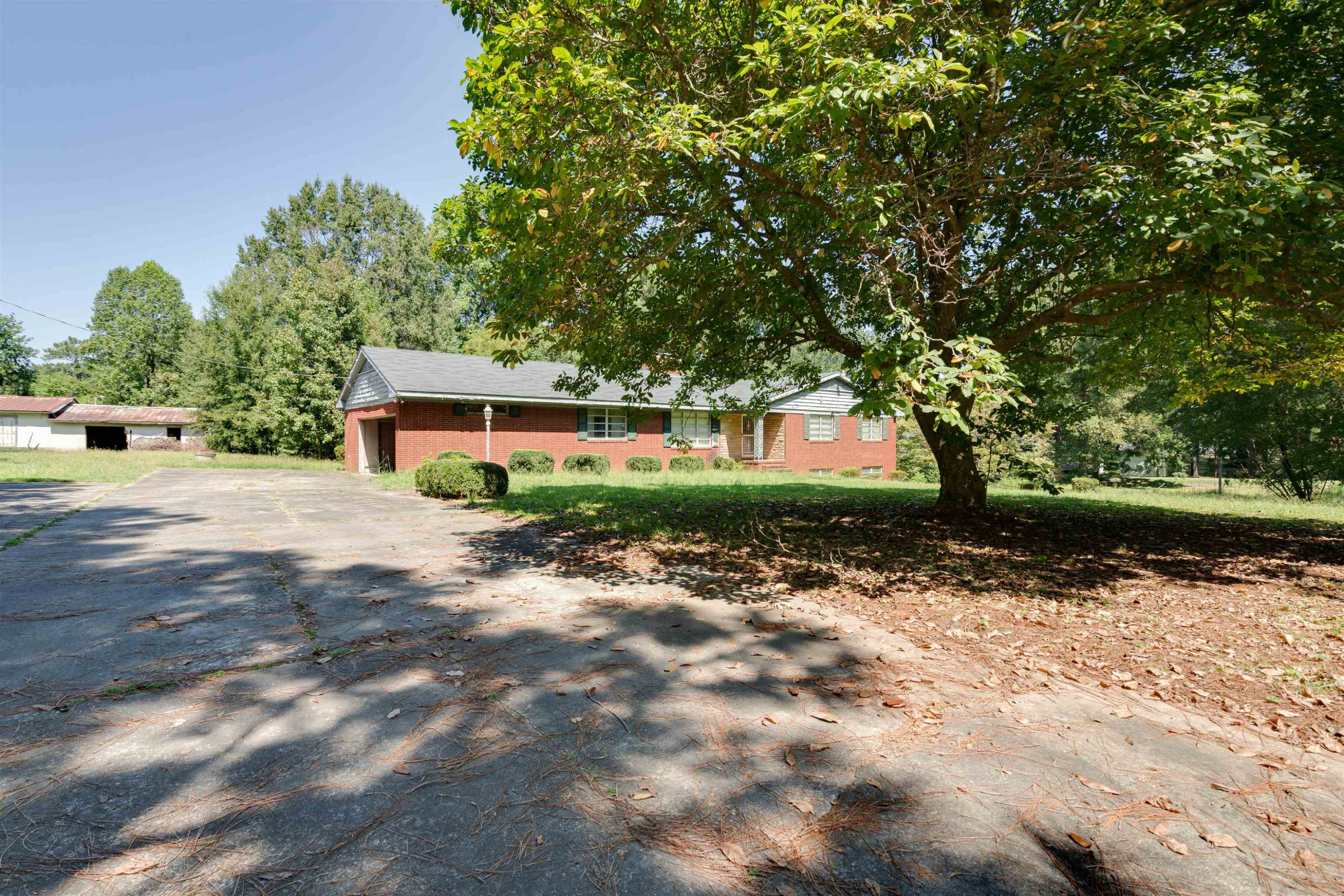 7676 Webbs Mill Road Spring Hope, NC 27882 - Photo 3 of 10 a front view of a house with a yard and a garage