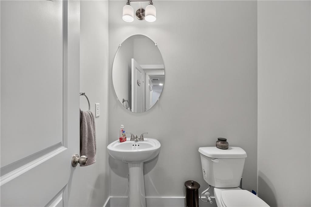 139 Manchester Lane Villa Rica, GA 30180 - Photo 22 of 60 a bathroom with a toilet sink and mirror