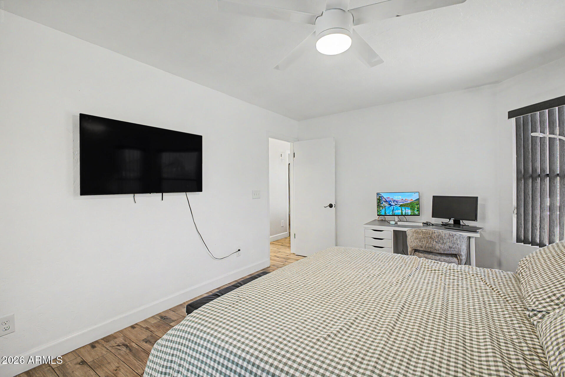 4725 East Brown Road, Unit 70 Mesa, AZ 85205 - Photo 15 of 25 a bedroom with a bed and a flat screen tv