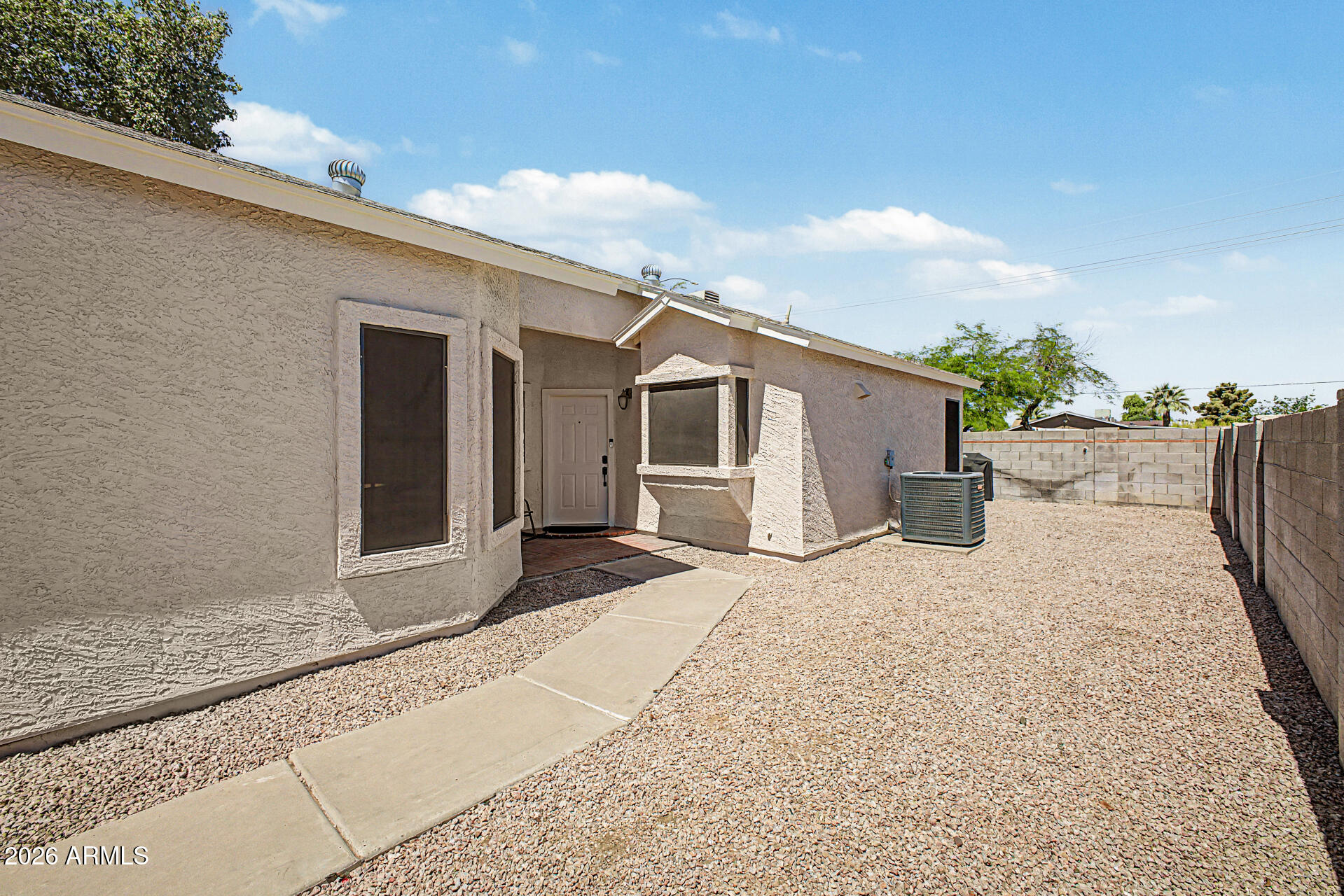 4725 East Brown Road, Unit 70 Mesa, AZ 85205 - Photo 4 of 25 a front view of a house with a yard