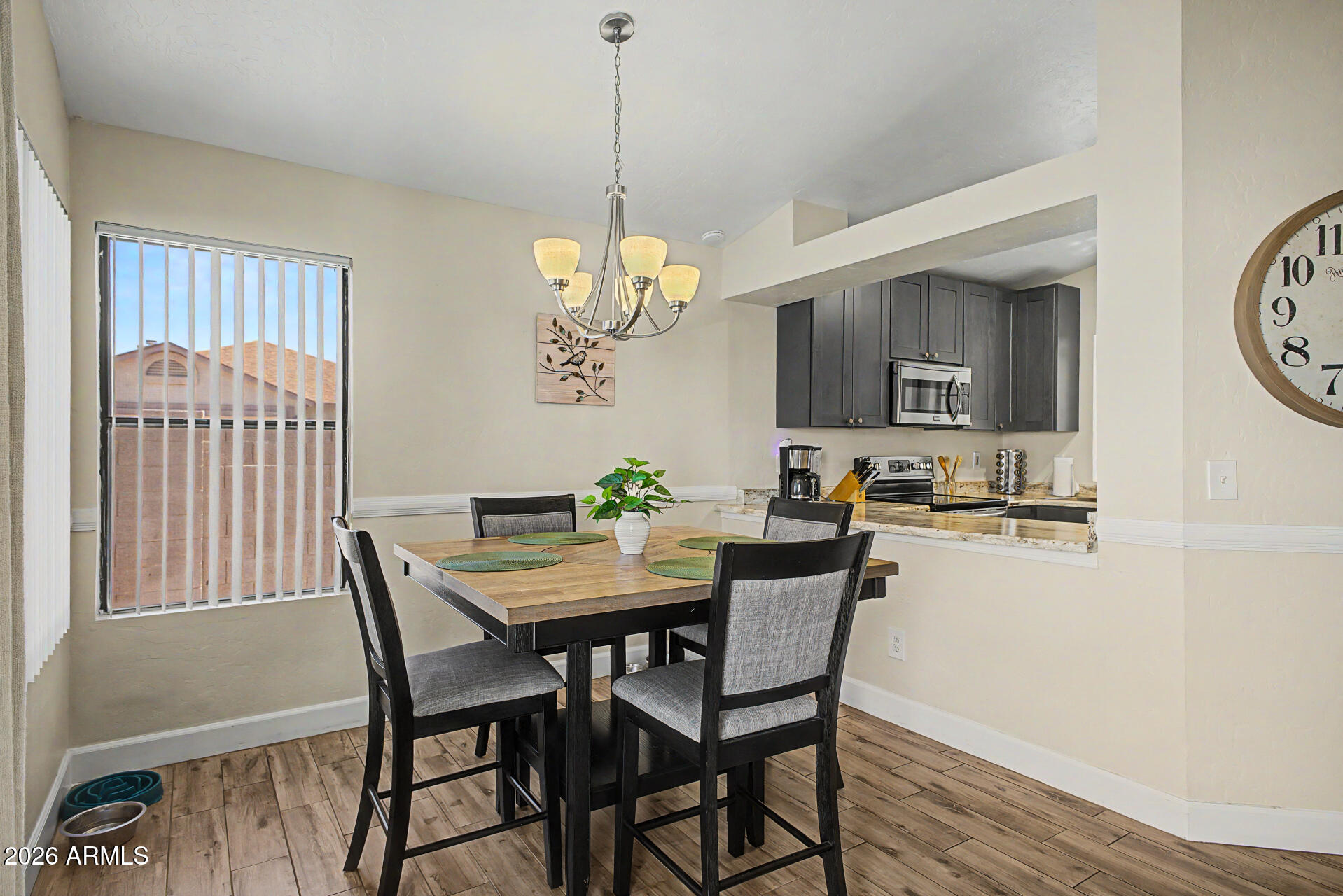 4725 East Brown Road, Unit 70 Mesa, AZ 85205 - Photo 9 of 25 a view of a dining room with furniture window and wooden floor