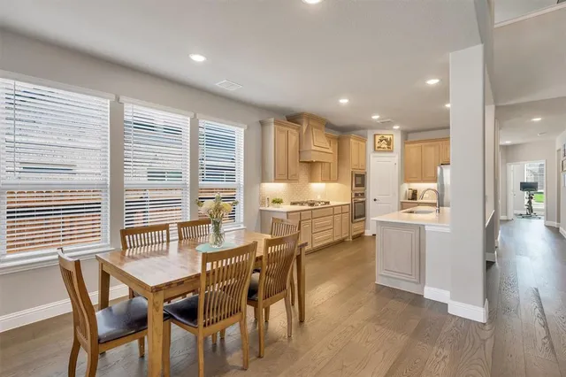a dining room with furniture and large windows