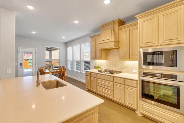 a large kitchen with stainless steel appliances lots of counter top space