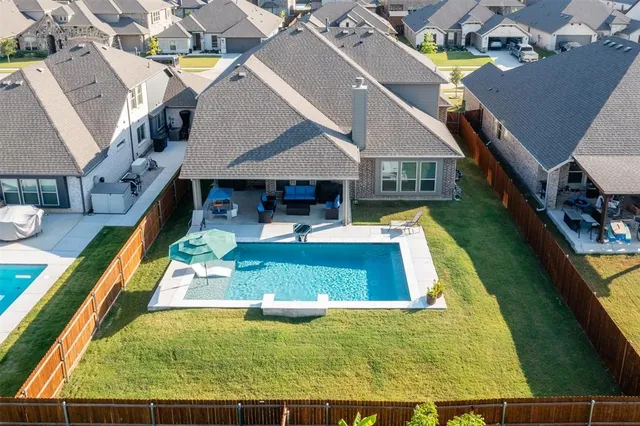an aerial view of a house with swimming pool