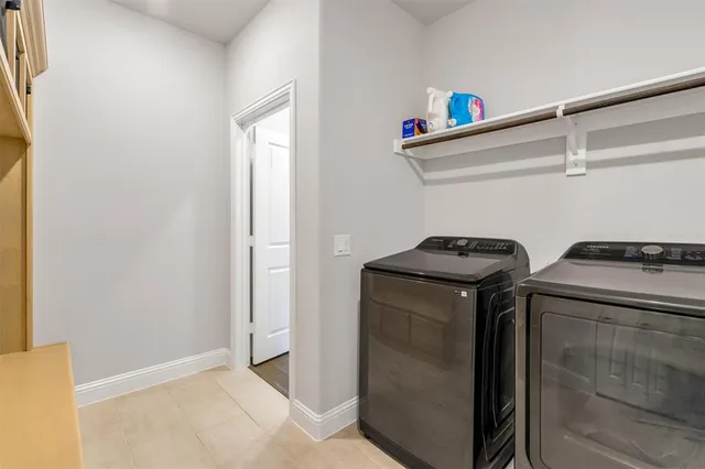 a spacious bathroom with a double vanity sink a mirror a bathtub and window
