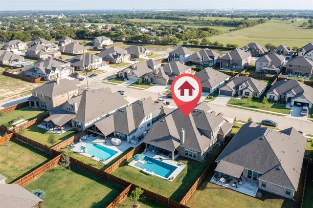 a living room with patio furniture and a floor to ceiling window