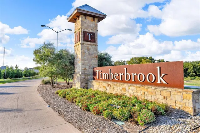 a view of a house with pool lawn chairs and a yard