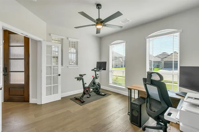 a view of a workspace with furniture and a window
