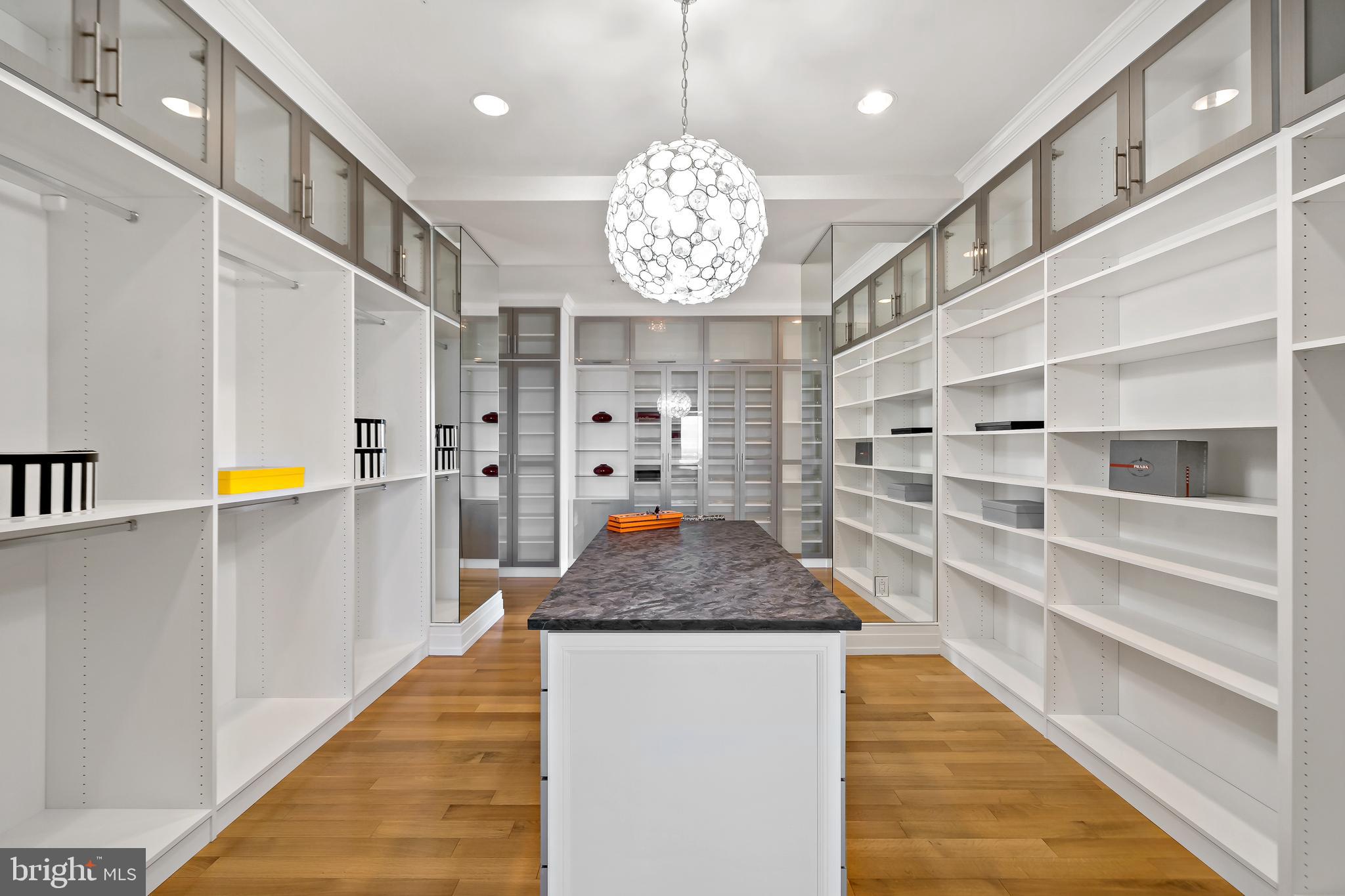 130 South 18th Street, Unit 3102 Philadelphia, PA 19103 - Photo 22 of 43 Island with Chandelier Anchors the Custom Closet