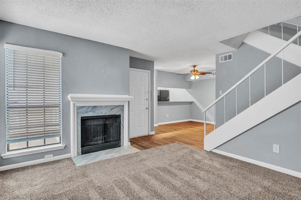11311 Audelia Road, Unit 221 Dallas, TX 75243 - Photo 2 of 22 a view of a livingroom with a fireplace and stairs