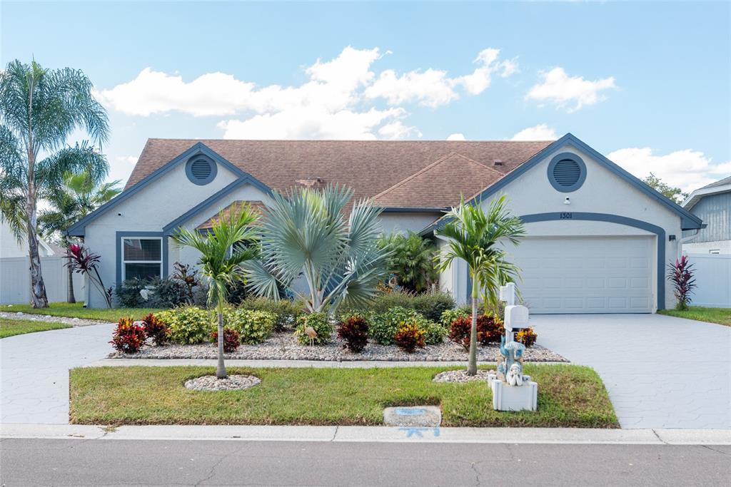 a front view of house with yard and green space