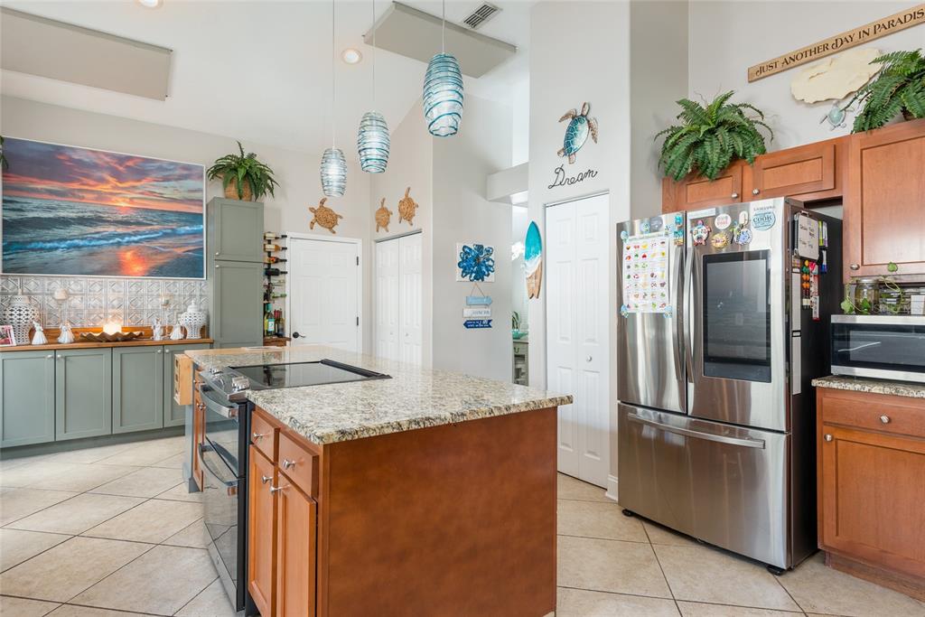 1301 Monte Lake Drive Valrico, FL 33596 - Photo 12 of 36 a kitchen with stainless steel appliances granite countertop a refrigerator a stove and a sink