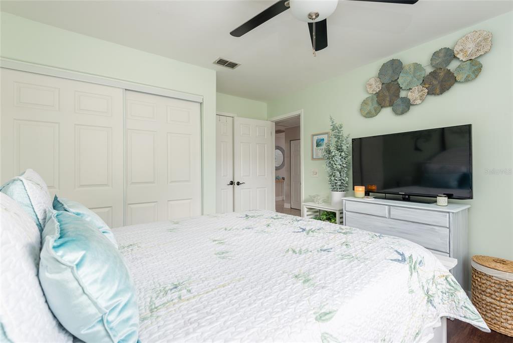 1301 Monte Lake Drive Valrico, FL 33596 - Photo 17 of 36 a bedroom with a bed and a flat screen tv