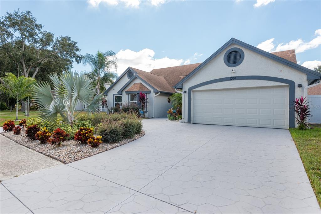 1301 Monte Lake Drive Valrico, FL 33596 - Photo 36 of 36 a front view of a house with a yard and potted plants