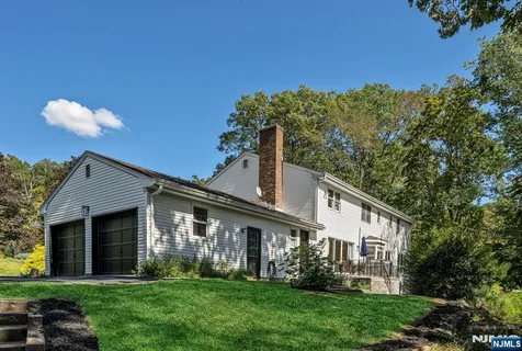 a front view of a house with a garden and plants