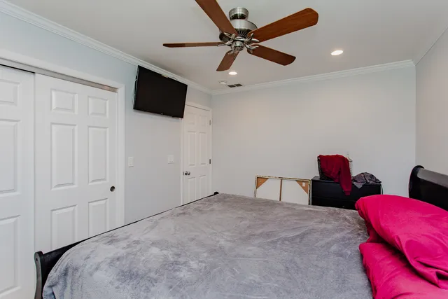 a bedroom with furniture and a flat screen tv