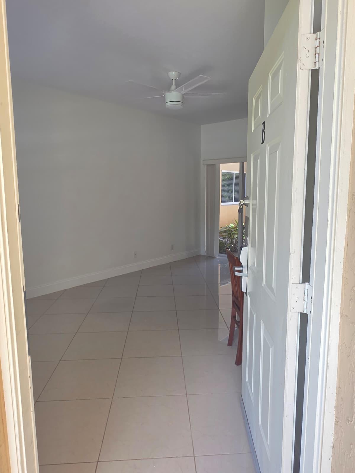 8262 Mulligan Circle, Unit 2613 SIDE B Port St. Lucie, FL 34986 - Photo 3 of 13 a view of a hallway with a livingroom and a bathroom with a sink
