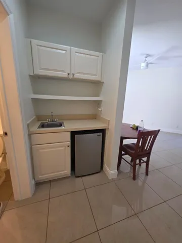 a view of a workspace with furniture and a gate